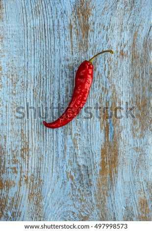 Red hot natural chili pepper on blue wooden weathering backgroung