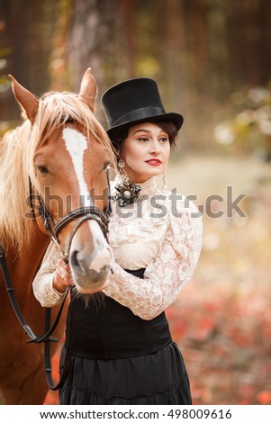 Portrait of beautiful woman in vintage stylized suit and top hat with a horse.