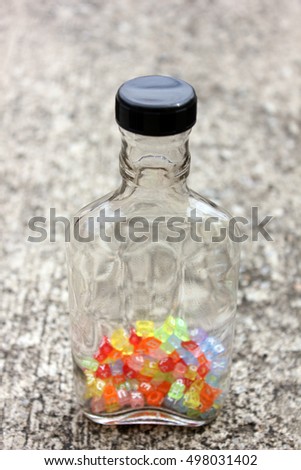 bottle containing the letter dice.