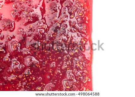 homogeneous mass of delicious red raspberry jam, flat top view, isolated on white background