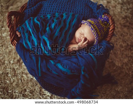 Incredible and sweet newborn baby sleeps in basket