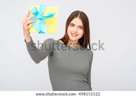 Present. woman in black dress holding gift