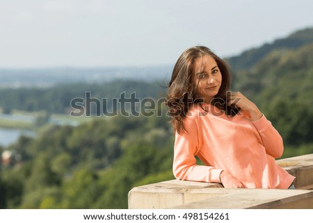 Attractive young woman posing for the photographer outdoors.