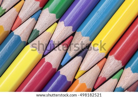 foreground of some crayons interleaved on a diagonal composition