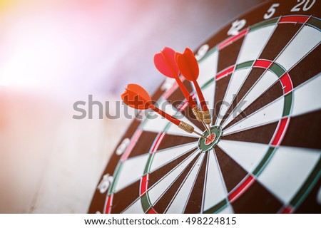 red three darts arrows in the target center business goal concept