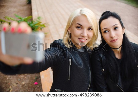 Girls make selfie in autumn park