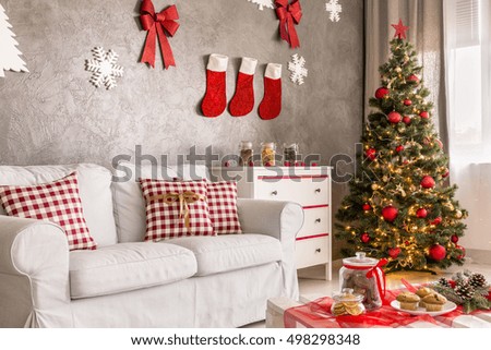 Modern living room in grey and white with christmas tree and DIY wall decor Royalty-Free Stock Photo #498298348