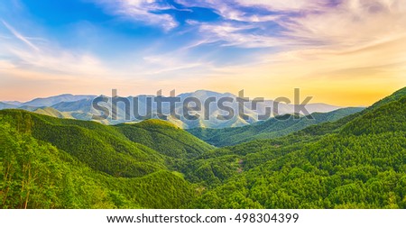 Panoramic view of a mountain valley at sunset time. Panorama Royalty-Free Stock Photo #498304399