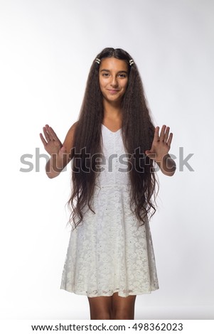 emotional young girl actress brunette with long hair in a white sundress on a white background