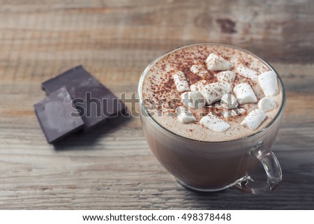 cup of hot cocoa with marshmallows on wooden background, selective focus