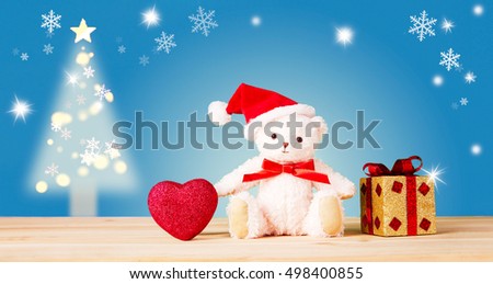 Cute teddy bear santa with gold giftbox and heart. Retro vintage mood Christmas and holiday greeting card. 