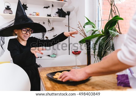 Girl in Witch costume doing magic tricks
