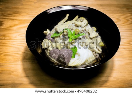 Green curry in a black bowl . Green curry Delicious Recommended dishes in Thailand.