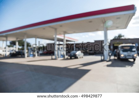 Blurred of gas station with car fill up fuel in daytime. Defocused, out of focus gas station in the morning. Abstract blur petrol station background with copy space