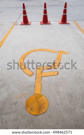 Disabled parking or Disabled sign on the road with traffic cone