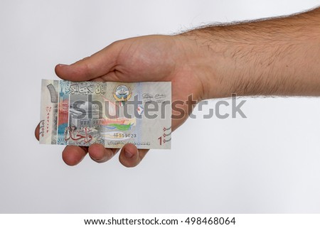 Kuwaiti dinar banknote in hand. Kuwaiti dinar is the national currency of Kuwait