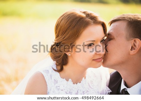 portrait of a couple bride and groom on the background of field.