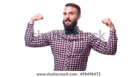 Young guy with red checkered shirt and green bow tie, pulling biceps with his two arms , isolated on white