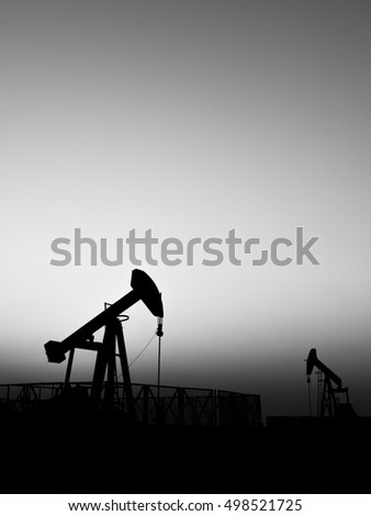 Silhouette of oil pump in the oil field -black and white 
