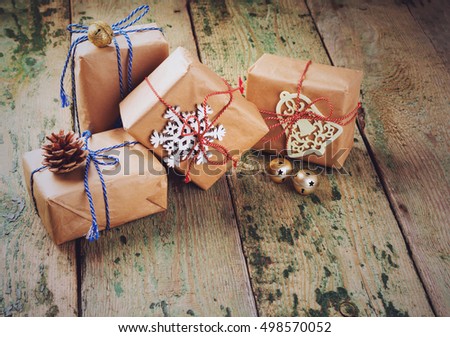Christmas composition with  toys pine cones, gift box  on a dark wooden background. Toned image. Selective focus.