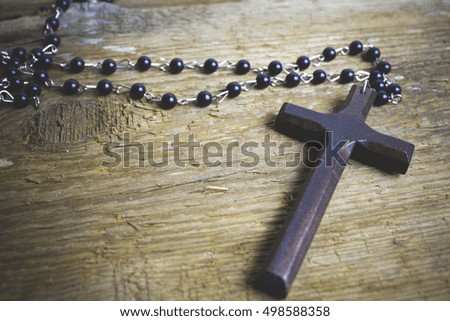 wooden cross on wood background