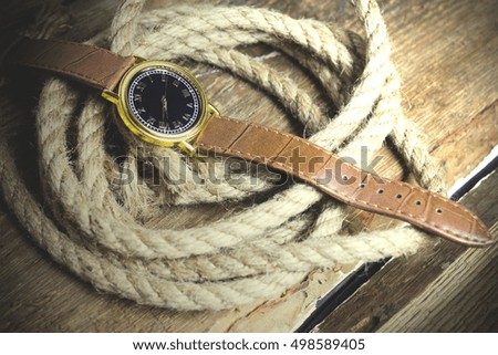 rope wristwatch on wooden table