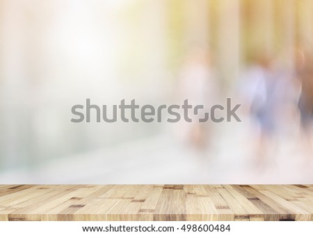 empty brown wooden table and office blur background with bokeh image, for product display montage