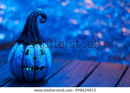 Halloween Celebration Background With Glitter Pumpkin Glowing. Selective Focus With Copy Space. Blue Color Tone Filter Applied.