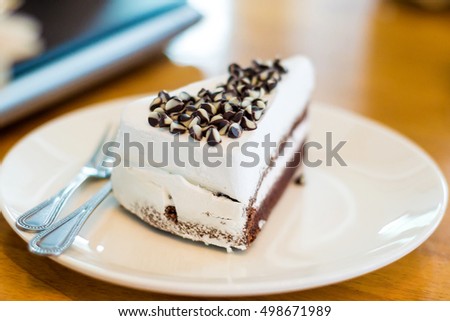 Delicious white cake with chocolate on disk