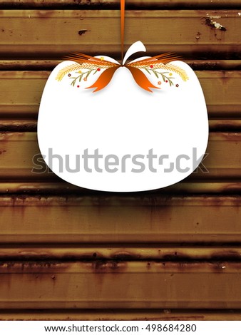 Close-up of one blank pumpkin shaped frame hanged by orange ribbon on brown rusty metal shutter background