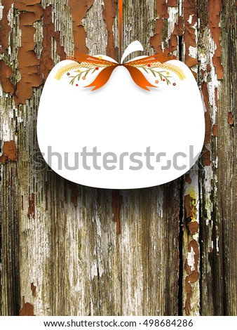 Close-up of one blank pumpkin shaped frame hanged by orange ribbon on peeled wooden background