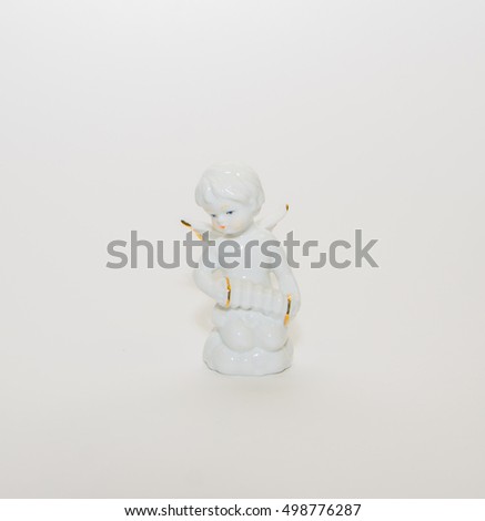 Christmas angel plays the accordion on a white background.
