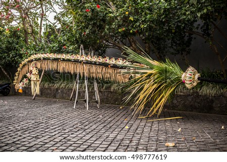 Bali Penjor decorated bamboo pole along the village street in Bali, Indonesia. Penjors are placed outside Balinese Hindu homes during religious holidays such as Galungan and Kuningan.