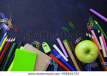 School supplies side border on a chalkboard background