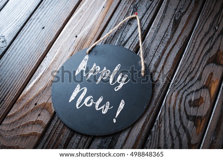 Apply Now Sign Written In Chalk On Chalkboard On Rustic Vintage Wood Background. Selective Focus.