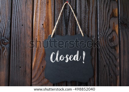 Closed Sign Written In Chalk On Chalkboard On Rustic Vintage Wood Background. Top View Selective Focus.