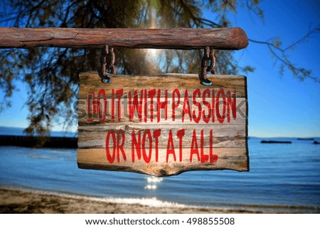 Do it with passion or not at all motivational phrase sign on old wood with blurred background