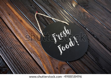 Fresh Food Sign Written In Chalk On Chalkboard On Rustic Vintage Wood Background. Selective Focus.