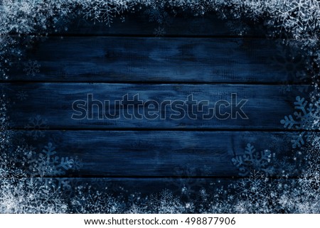Wooden winter background. Blue horizontal boards with snow and snowflakes. Background for design