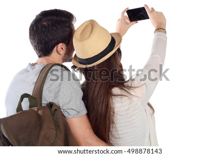 Portrait of a beautiful couple on a trip and taking selfie with smartphone. Travel concept. Isolated white background.
