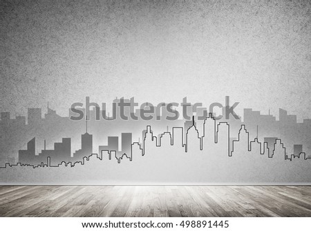 Silhouette of modern city landscape drawn on concrete wall