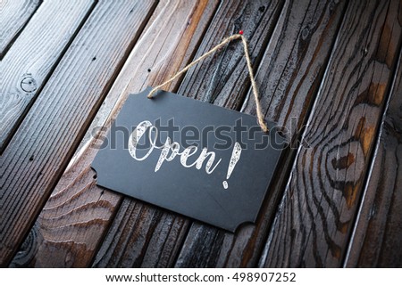 Open Sign Written In Chalk On Chalkboard On Rustic Vintage Wood Background. Selective Focus.