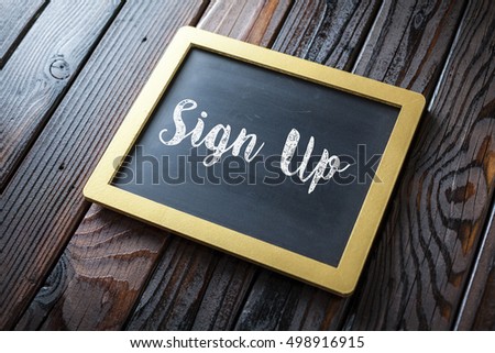 Sign Up Written In Chalk On Chalkboard On Rustic Vintage Wood Background. Selective Focus.