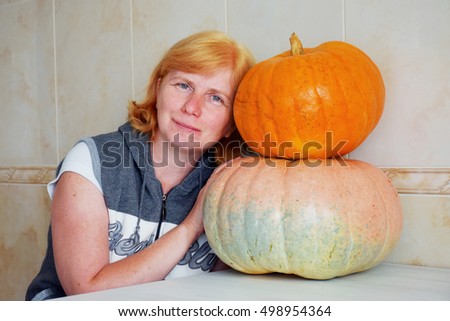Mature woman with two pumpkins
