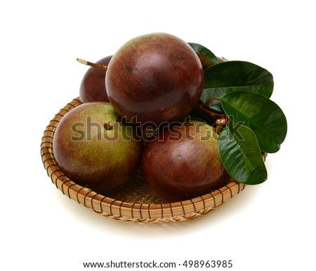 ripe star apple fruit in basket isolated on white background