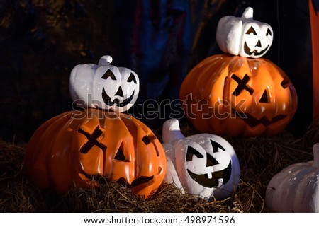 Halloween pumpkin on straw dry at night.