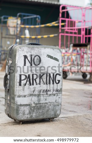 No parking sign on an old suitcase.