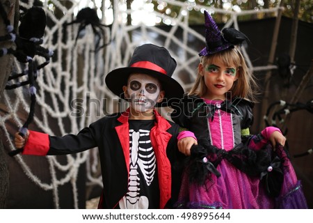 Trick or treat. Kids in a Halloween costume of skeleton with hat and smocking and witch. Halloween children