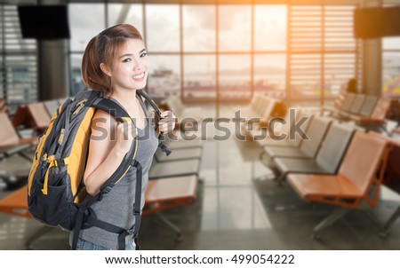 Happy asian woman travel at ferry terminal. Room passenger pier display blur in the background.