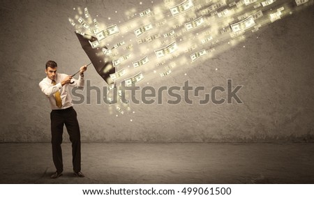 Business man holding umbrella against dollar rain concept on grungy background